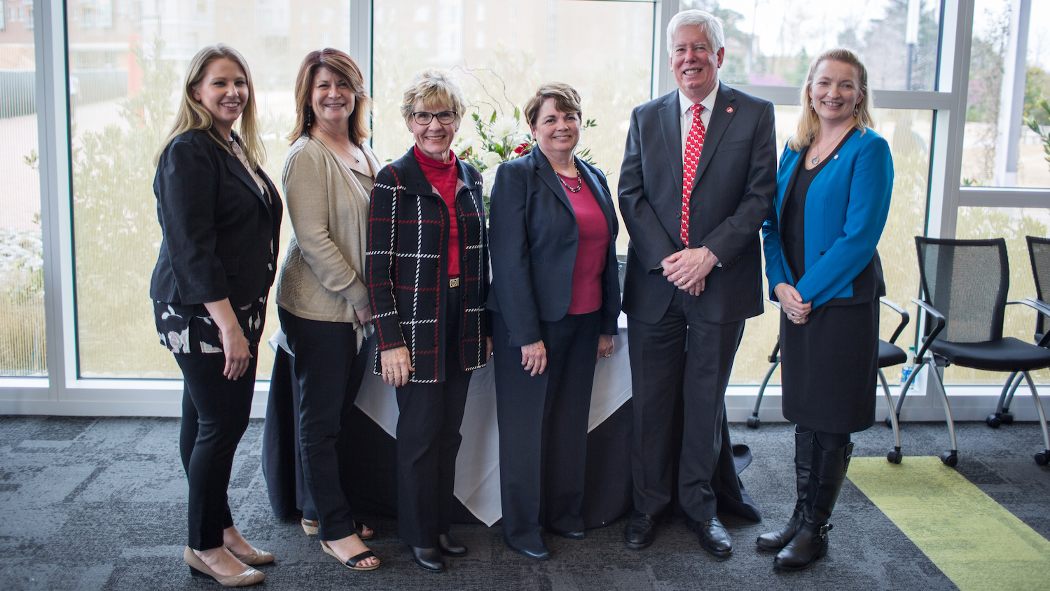 Swanson and colleagues posed in conference room.