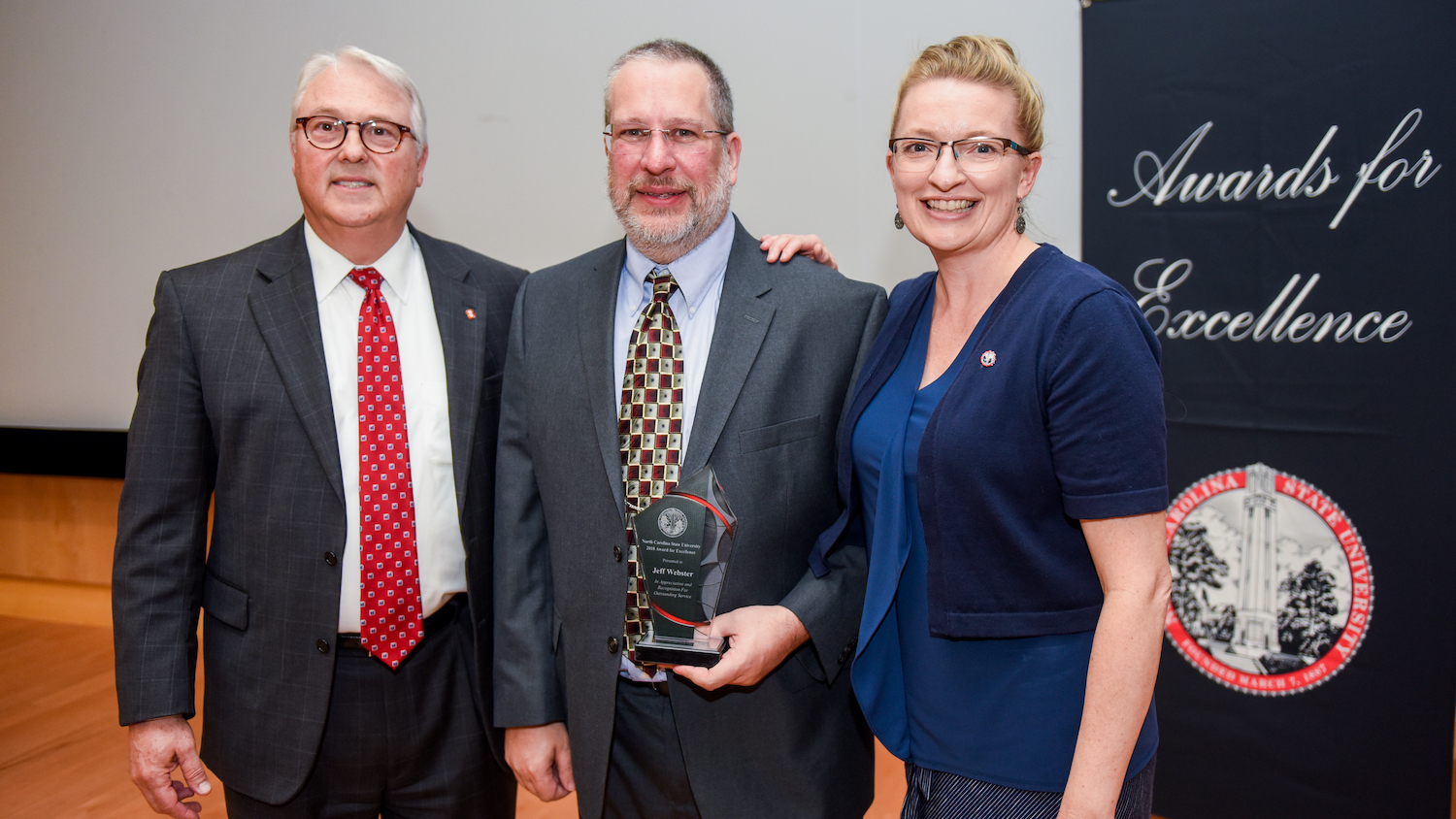 Chancellor Woodson, Webster and Donna Petherbridge posing with Webster and his award.