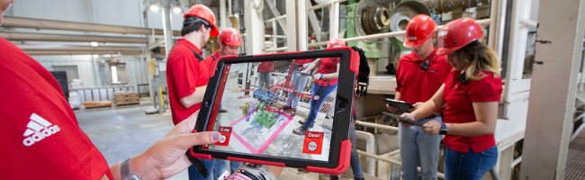 An immersive feed mill experience is displayed on an iPad